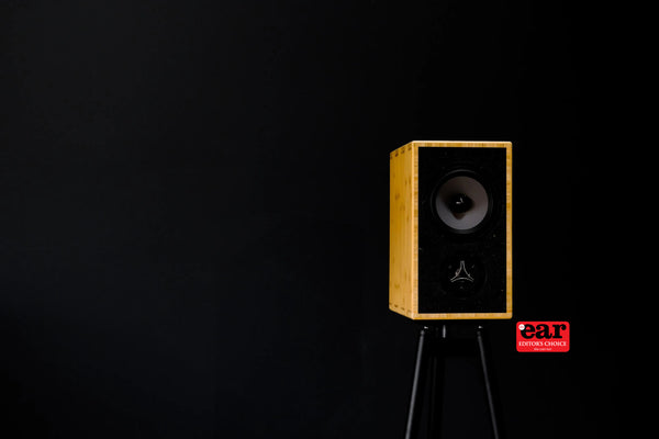 Bamboo speaker on a stand with a black background